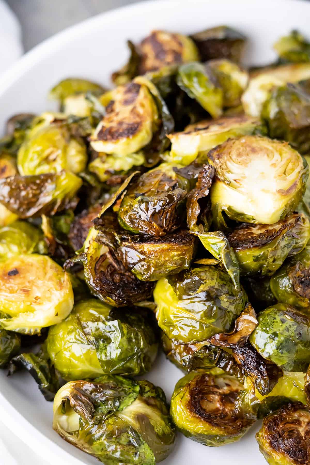 A close up of crispy roasted brussels sprouts to show the super crunchy little leaves lightly coated in oil.