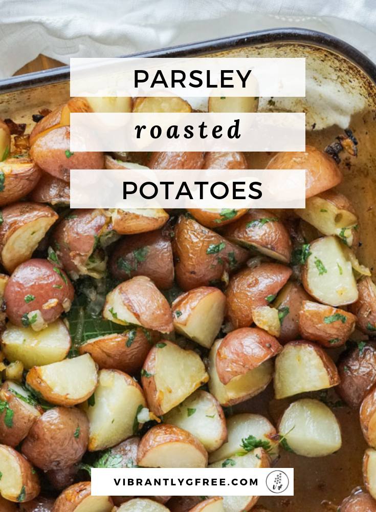 A large glass baking dish of steaming crispy parsley roasted potatoes ready to serve for the holidays!