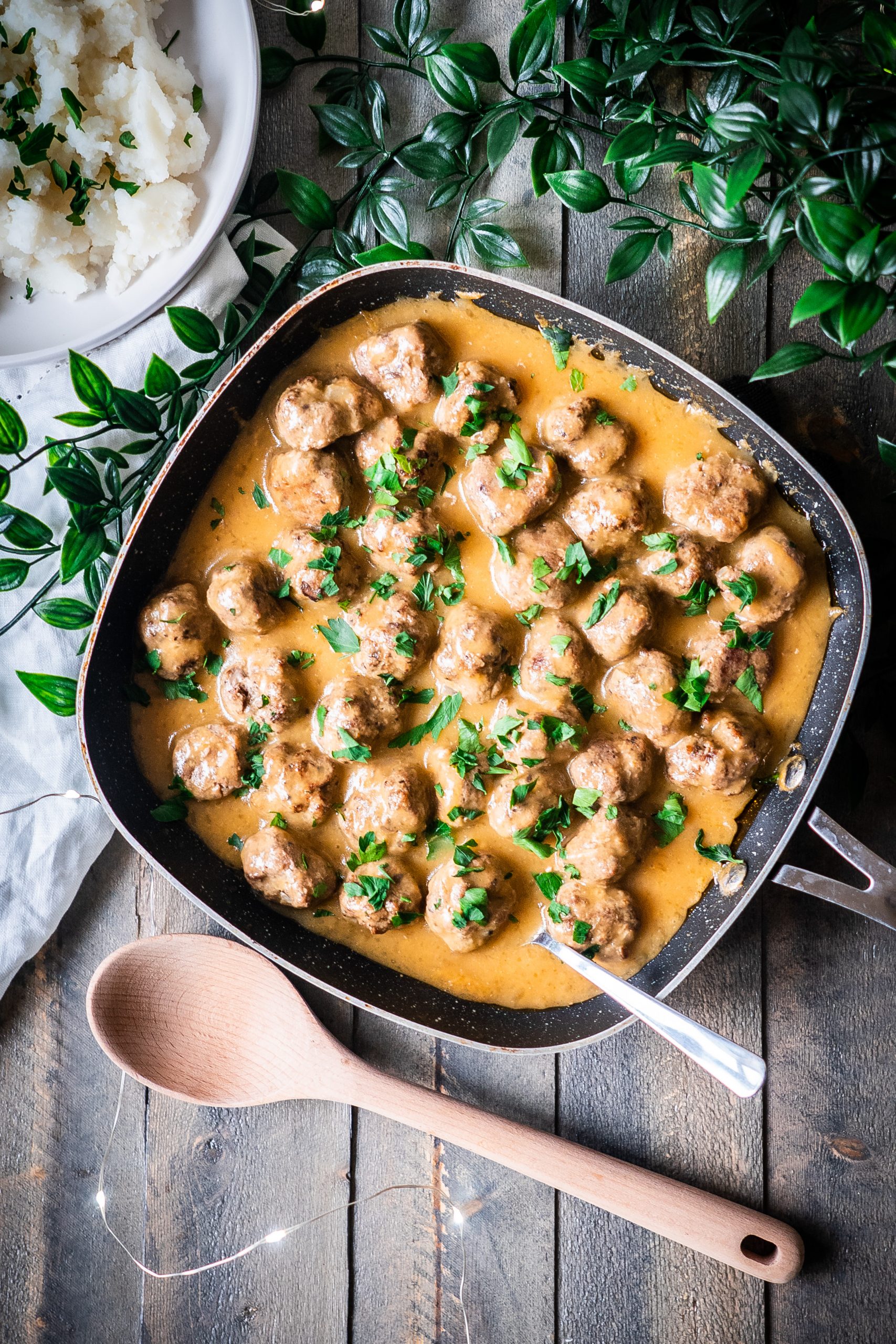 Overhead view of a sauce pan of dairy free swedish meatballs in dairy free gravy