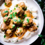 Overhead view of dairy free swedish meatballs smothered in gravy on mashed potatoes