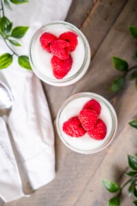 Overhead view of two Mocha Chia Pudding with fresh raspberries and vanilla coconut yogurt