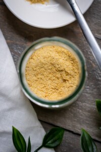 Vegan parmesan cheese texture showcased in a small jar