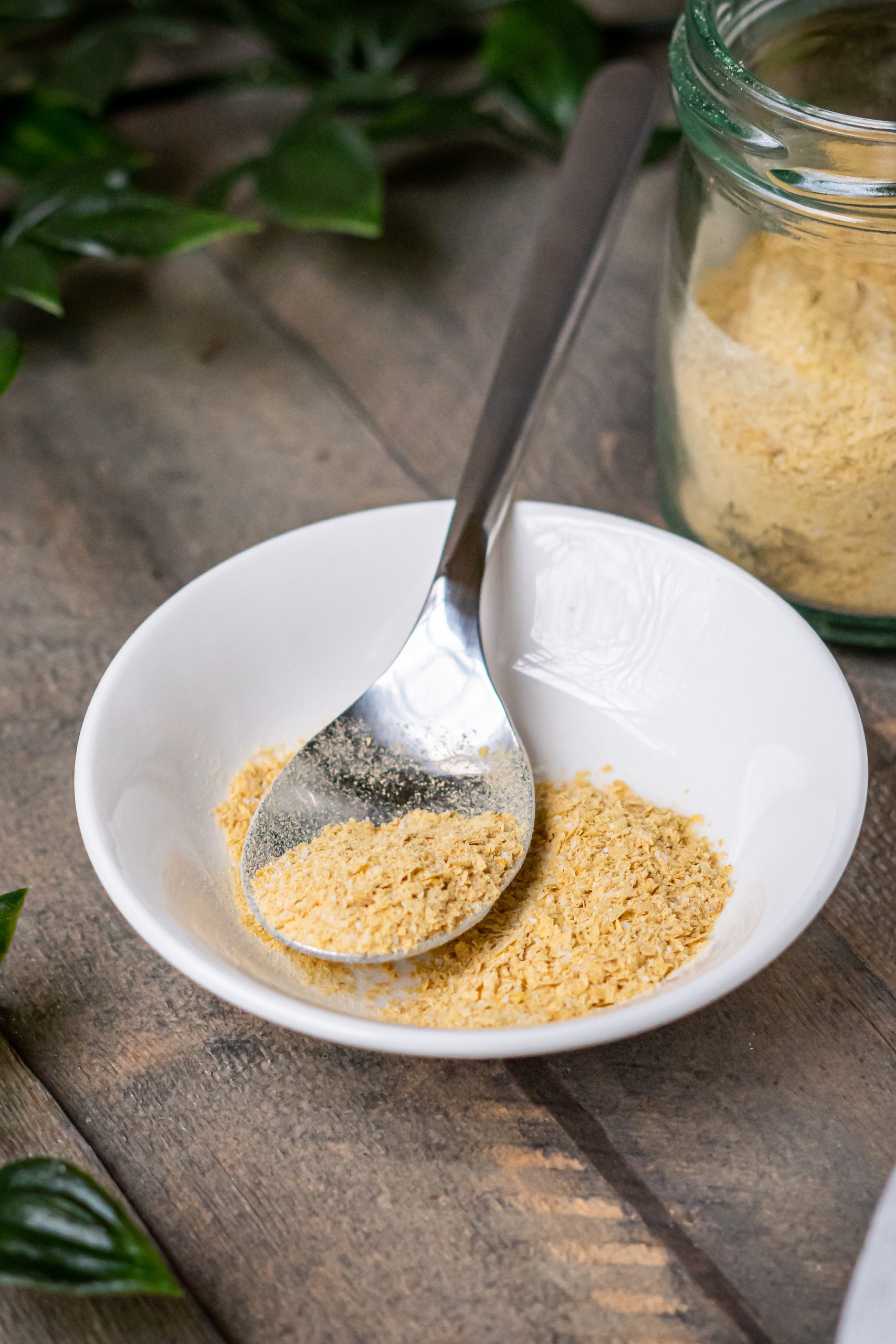 vegan parmesan cheese in a dish with a spoon
