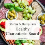 A gluten and dairy free charcuterie board with crackers, sliced meats, olives, fruits, and vegetables.