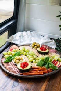 A gluten and dairy free charcuterie board resting on a counter in my camper van kitchen.