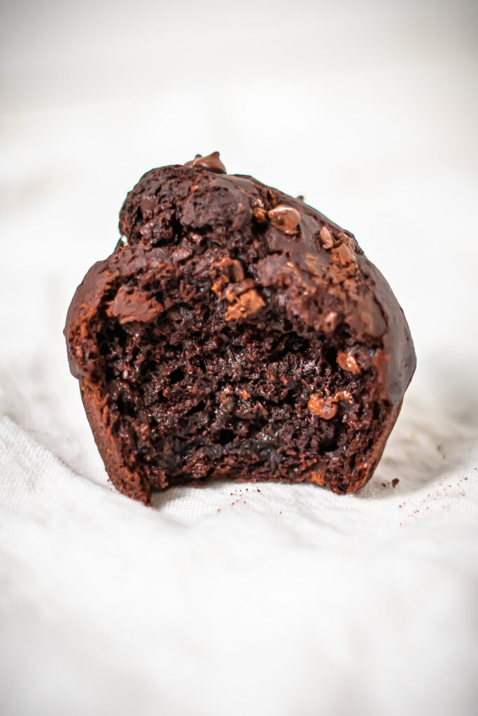 Close up of the inside of a gluten free chocolate muffin to show its moist texture.
