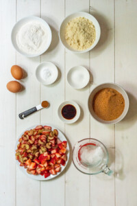 An overhead view of the 10 ingredients needed to make gluten free rhubarb cake.