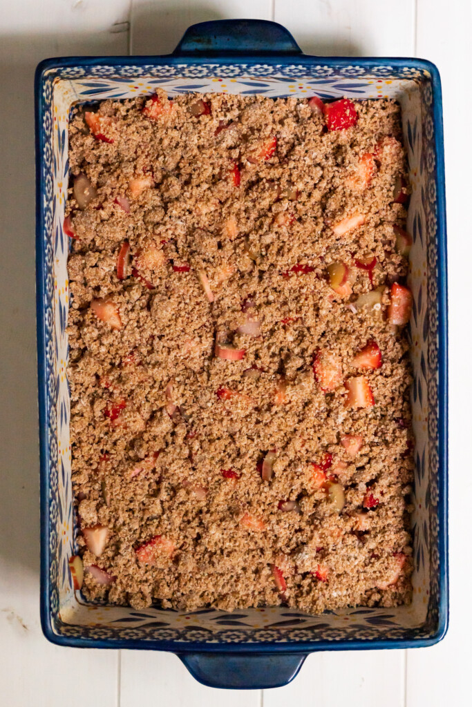 An overhead view of the baking dish ready to bake, with the streusel crumb evenly sprinkled on top.
