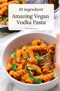 Side view of a bowl of creamy vegan vodka pasta with text overlay: Amazing Vegan Vodka Pasta.