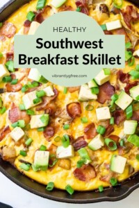 Overhead view of the Southwest Breakfast Skillet with avocado and green onions on top.