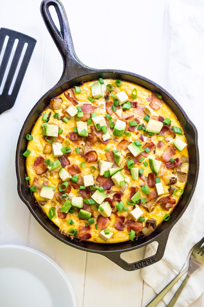 Overhead view of the Southwest Breakfast Skillet with avocado and green onions on top.