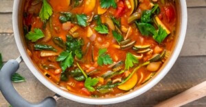 Overhead close up of Vegan MInestrone Soup in a 5 quart dutch oven.