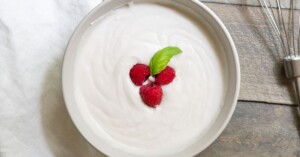 Overhead view of dairy free whipped cream with fresh mint and berries.