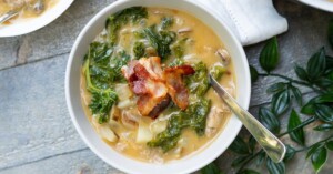 Final Healthy Zuppa Toscana soup served in a bowl with bacon pieces sprinkled on top.