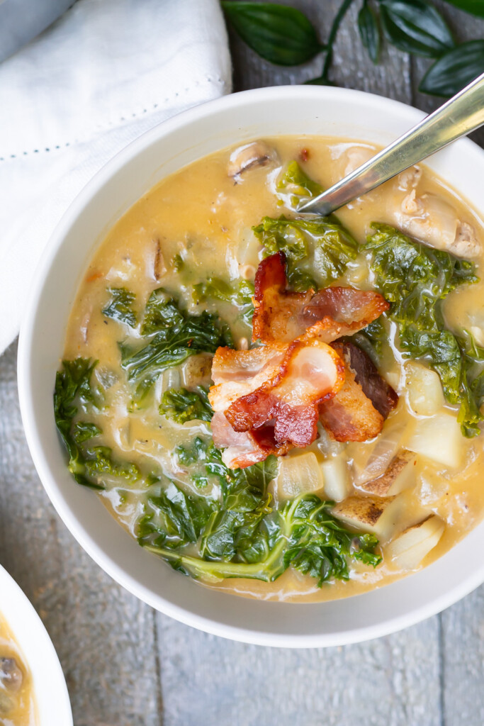 Overhead view of a healthy Zuppa Toscana without heavy cream garnished with bacon and ready for serving.
