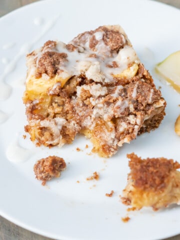 Side view of a slice of gluten-free apple coffee cake to show the three layers: cake, sliced apples, and crisp streusel.