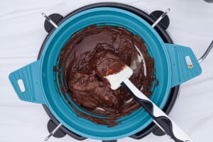 Overhead view of a medium pot with melted chocolate mixture for rocky road.