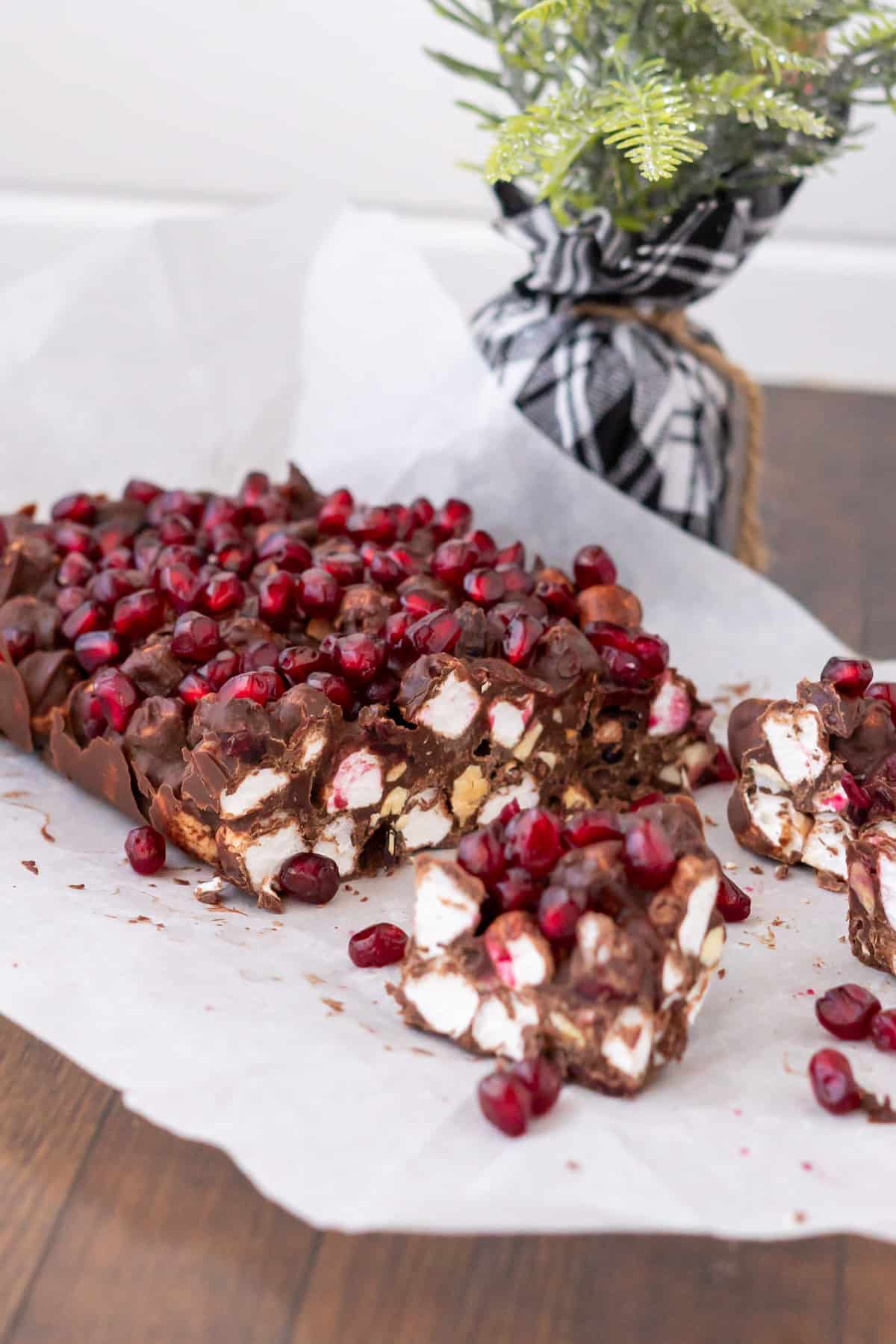 Side view of a Christmas Rocky Road loaf with one half cut into squares for serving.