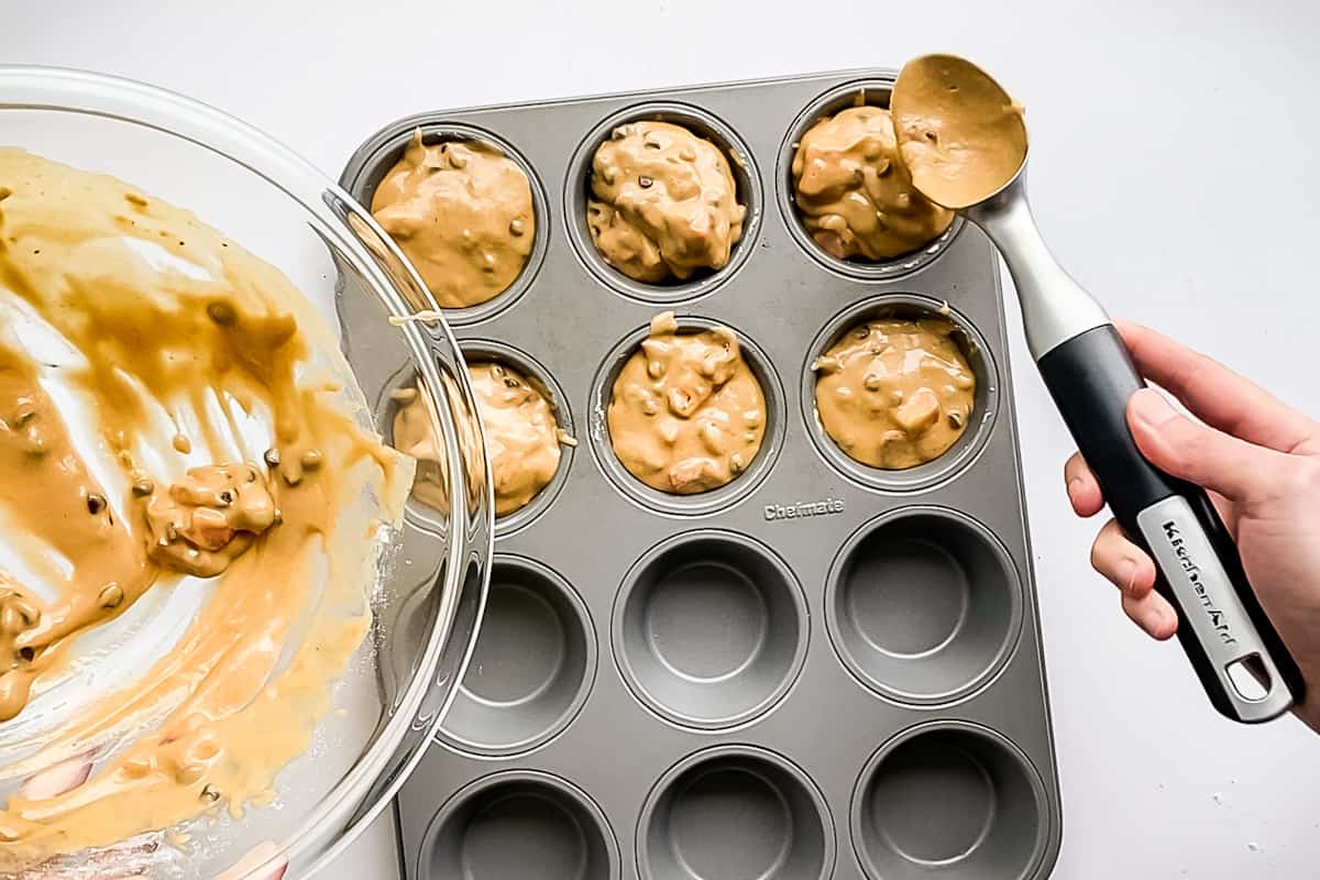 Six muffin cups filled to the top with gluten free strawberry muffin batter.