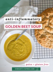Overhead view of a bright golden bowl of pureed beet soup beside a fresh loaf of gluten-free Irish Soda Bread.