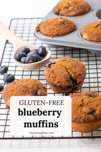 Gluten free blueberry muffins on a cooling rack and in a muffin tin.