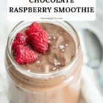 A chocolate raspberry smoothie with fresh raspberries and powdered sugar to garnish.
