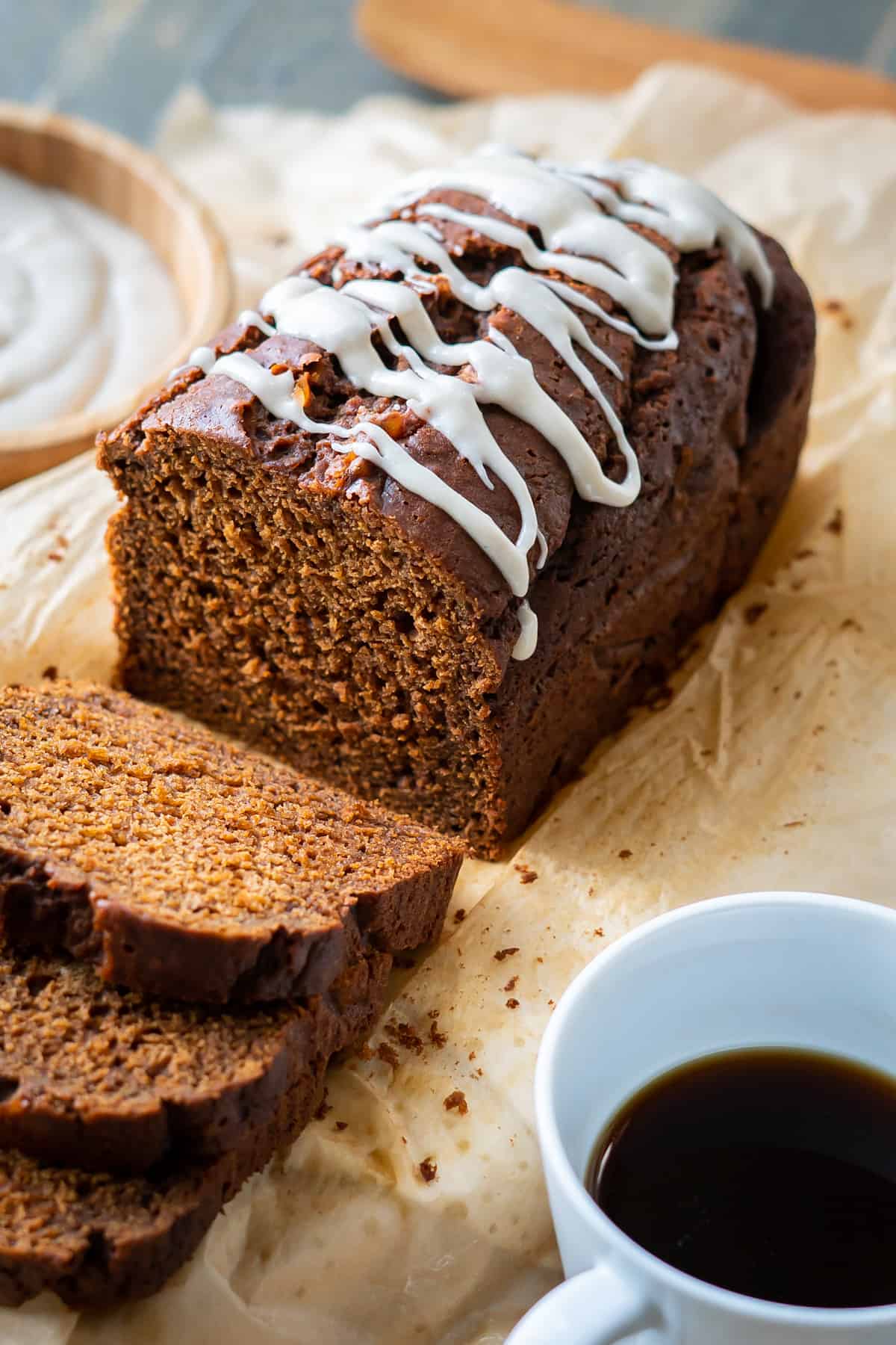 A sliced gingerbread loaf cake with icing.