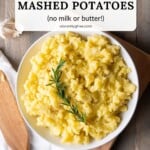 A serving bowl of Italian Olive Oil Mashed Potatoes garnished with rosemary with text overlay with the recipe name.