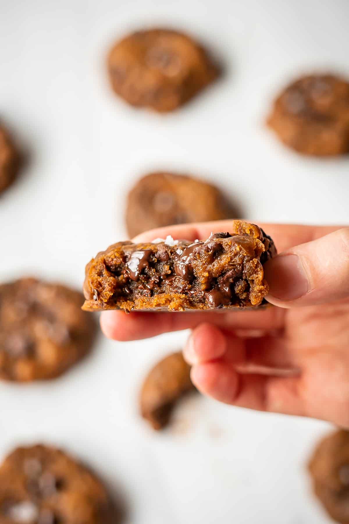 The inside of a coconut sugar chocolate chip cookie to show the soft and gooey inside and crisp outside.