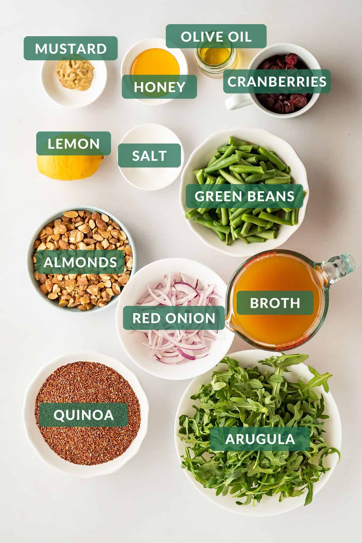 Prepared ingredients needed to make arugula quinoa salad.