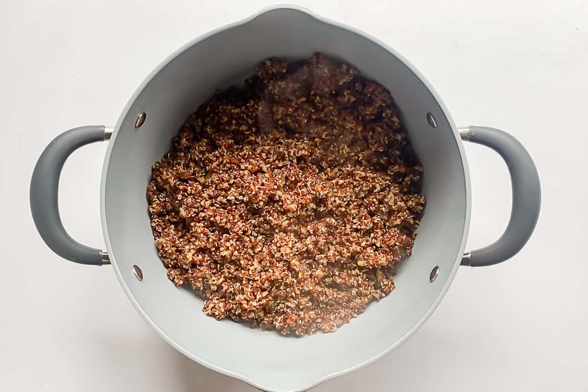 A large pot of cooked red quinoa.