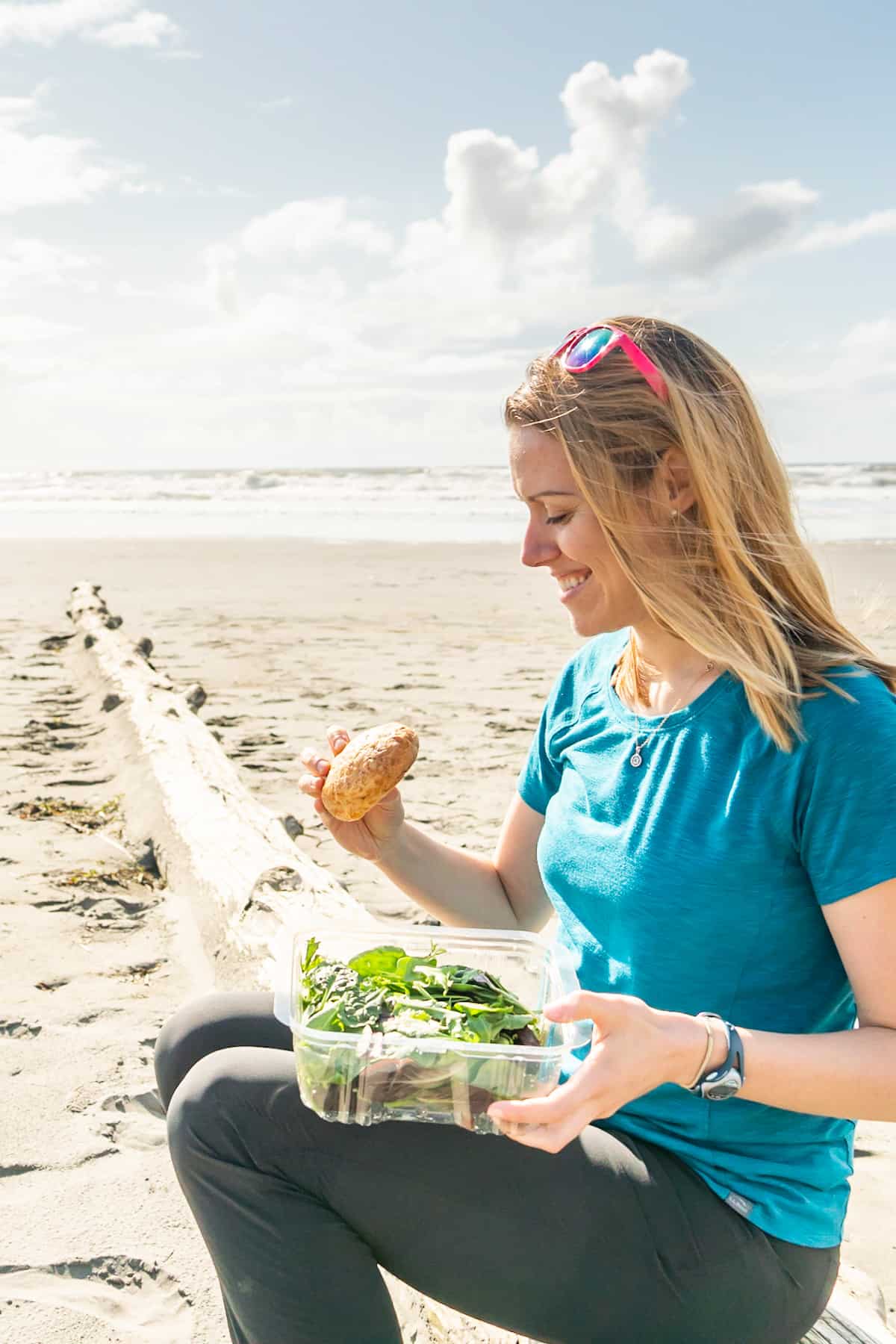 A women enjoying gluten free food on the beach.