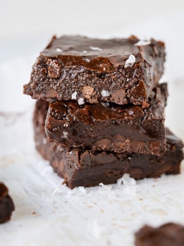 Three fudgy almond flour brownies in a stack.
