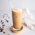 A tall glass of iced brown sugar shaken espresso with whipped cream.