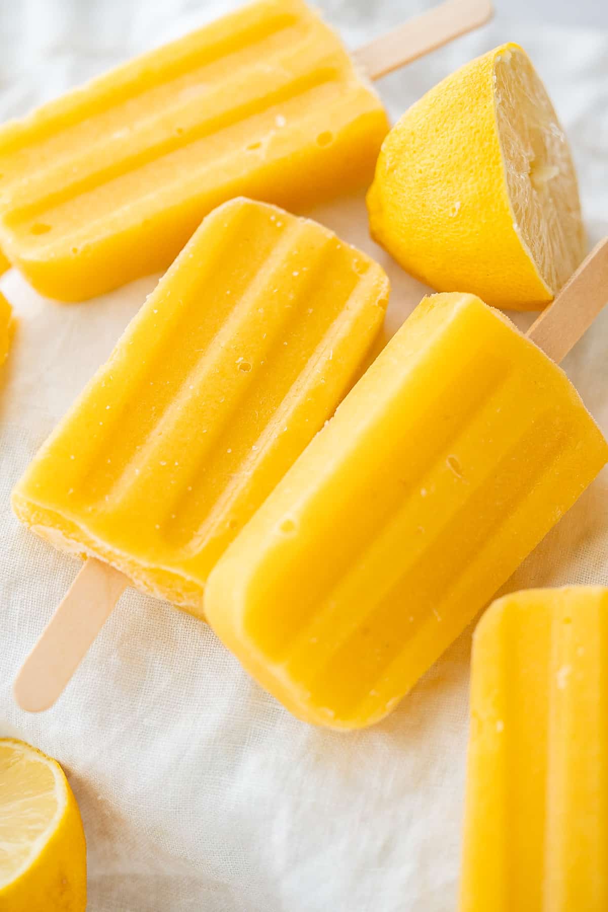 A close up of two healthy mango popsicles.