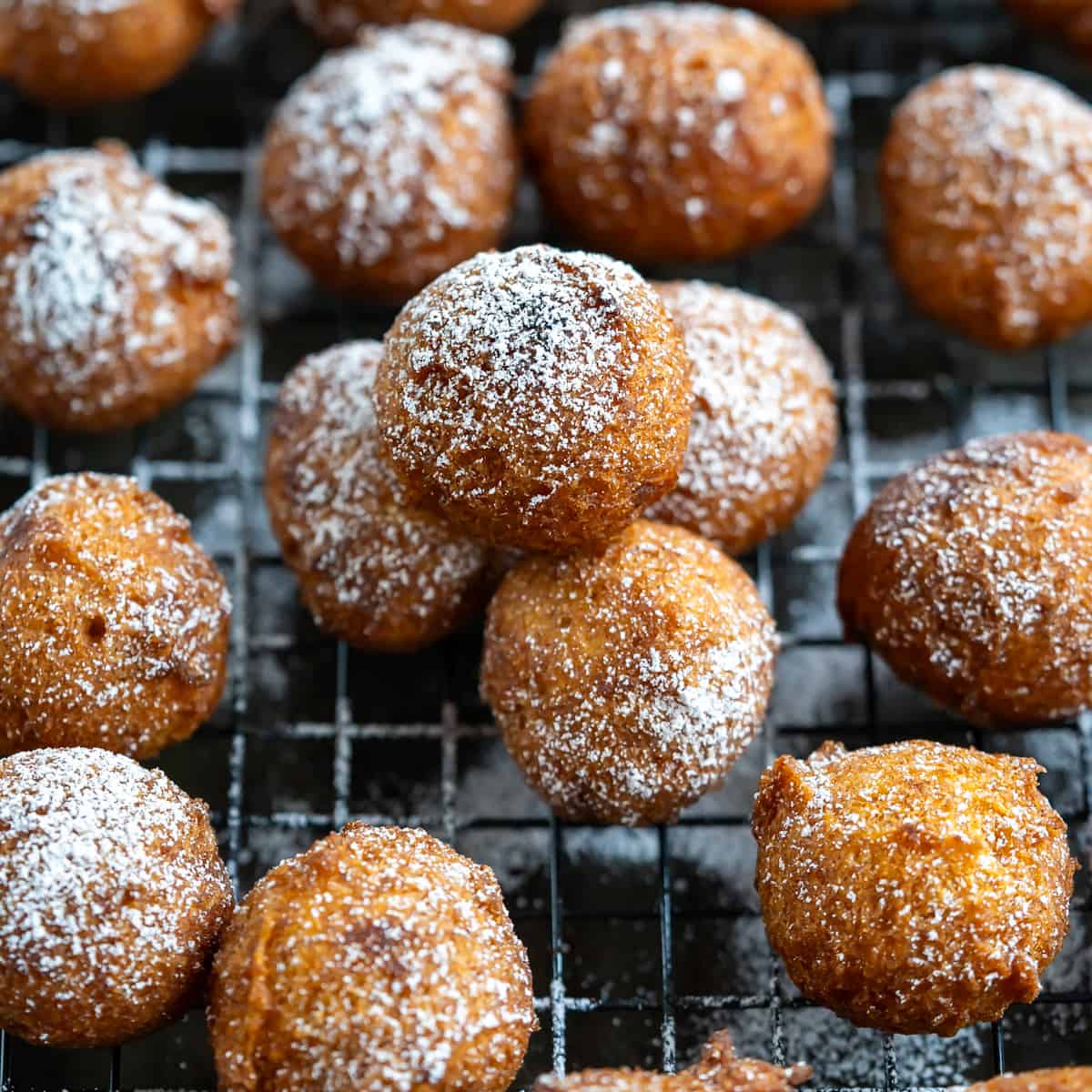A tray of freshly fried gluten free pumpkin donut holes.