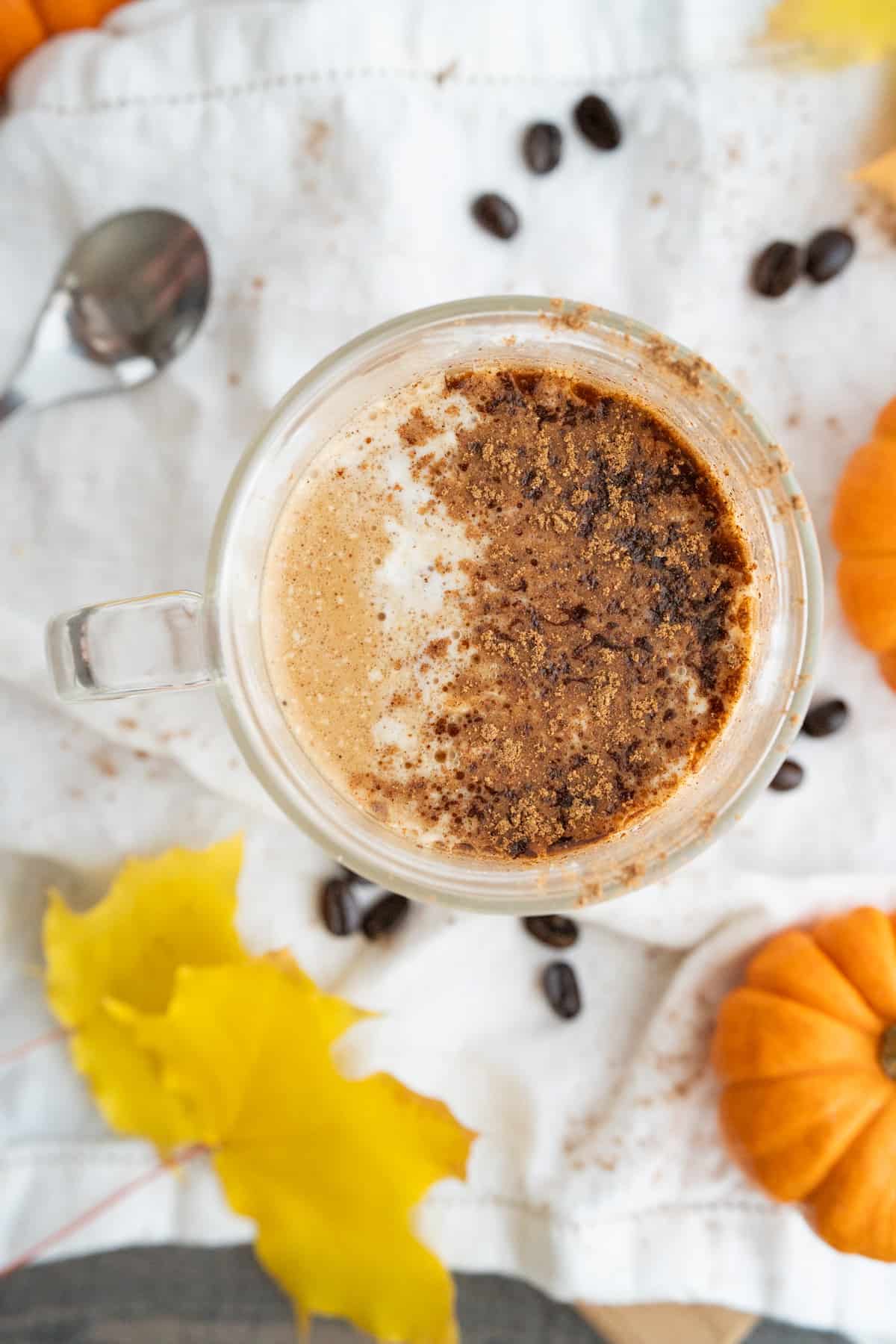 A homemade pumpkin spice latte topped with foam and cinnamon.