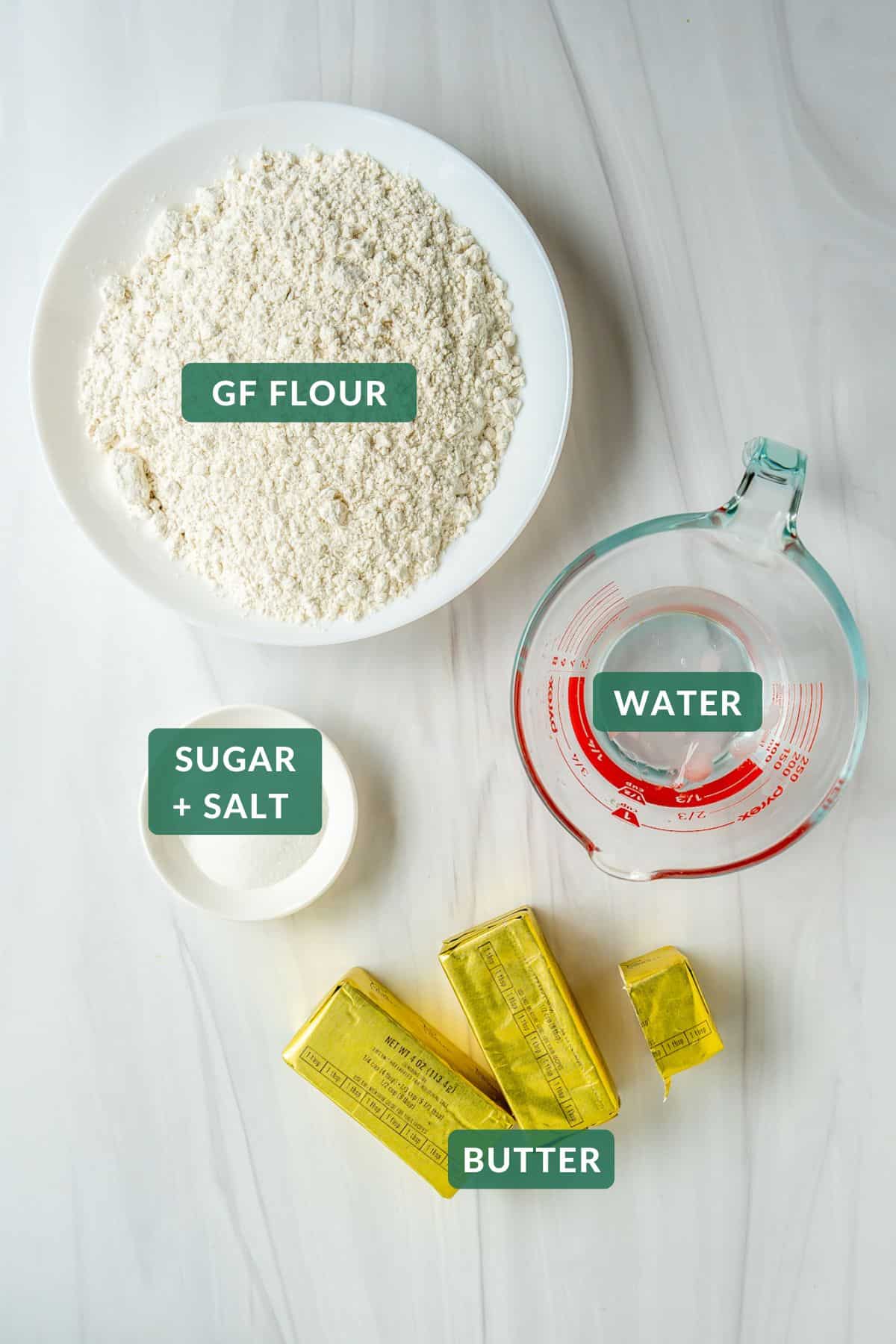 Gluten-free pie crust ingredients: GF Flour, sticks of butter, sugar, salt, and ice water.