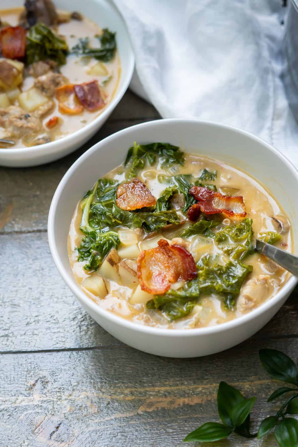 Two bowls of healthy zuppa toscana without heavy cream in bowls.