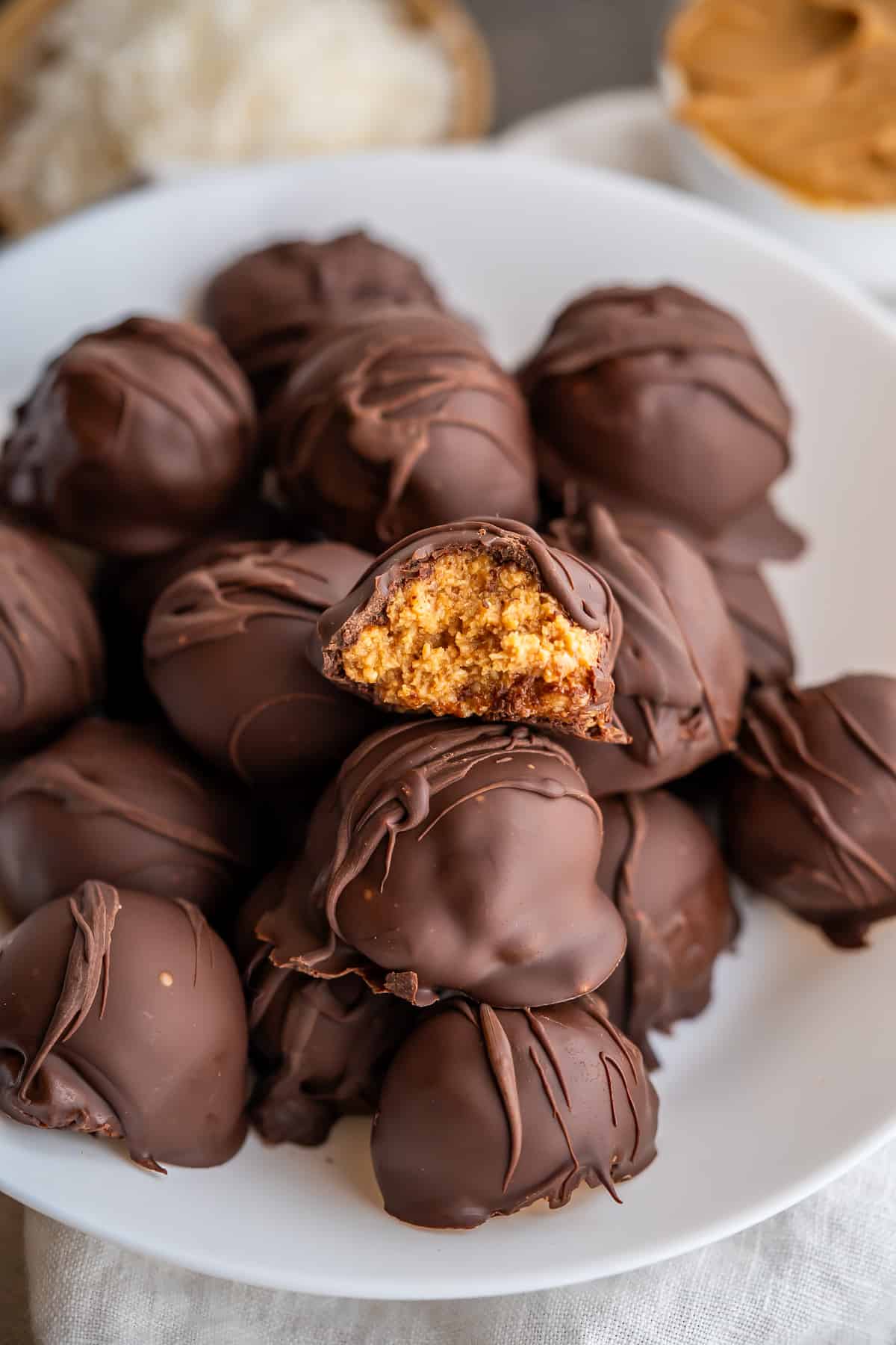 Half of a healthy peanut butter ball to show the inner filling texture and chocolate shell.