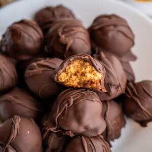 Half of a healthy peanut butter ball to show the inner filling texture and chocolate shell.
