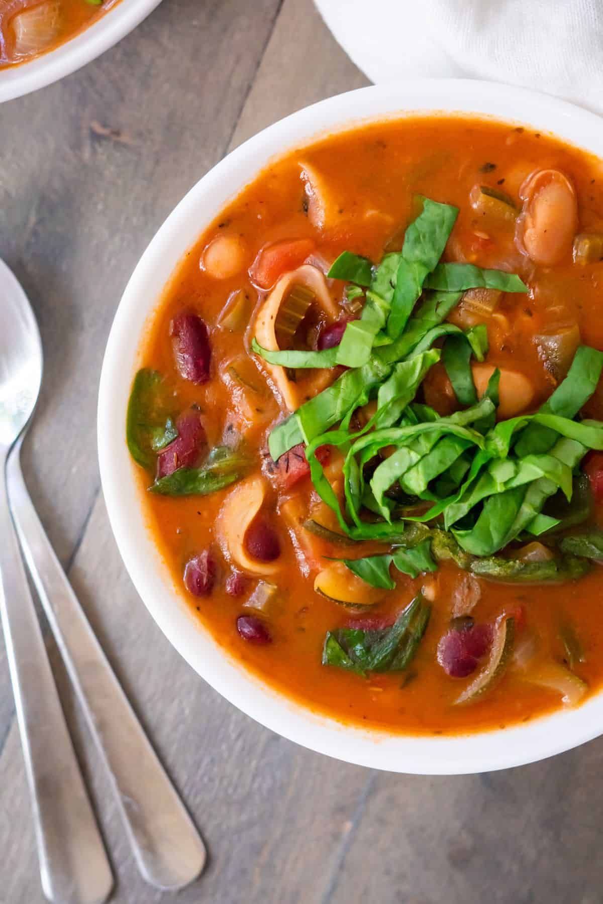 A colorful bowl of instant pot minestrone soup filled with healthy vegetables.
