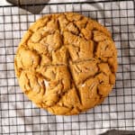 A round loaf of gluten-free Irish Soda Bread on a cooling rack.