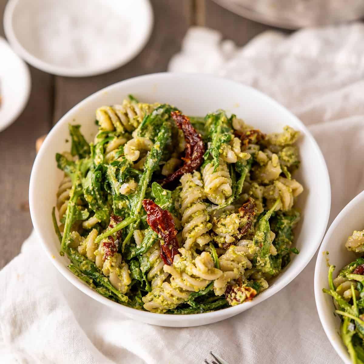 A serving bowl of vegan pea pesto pasta salad.