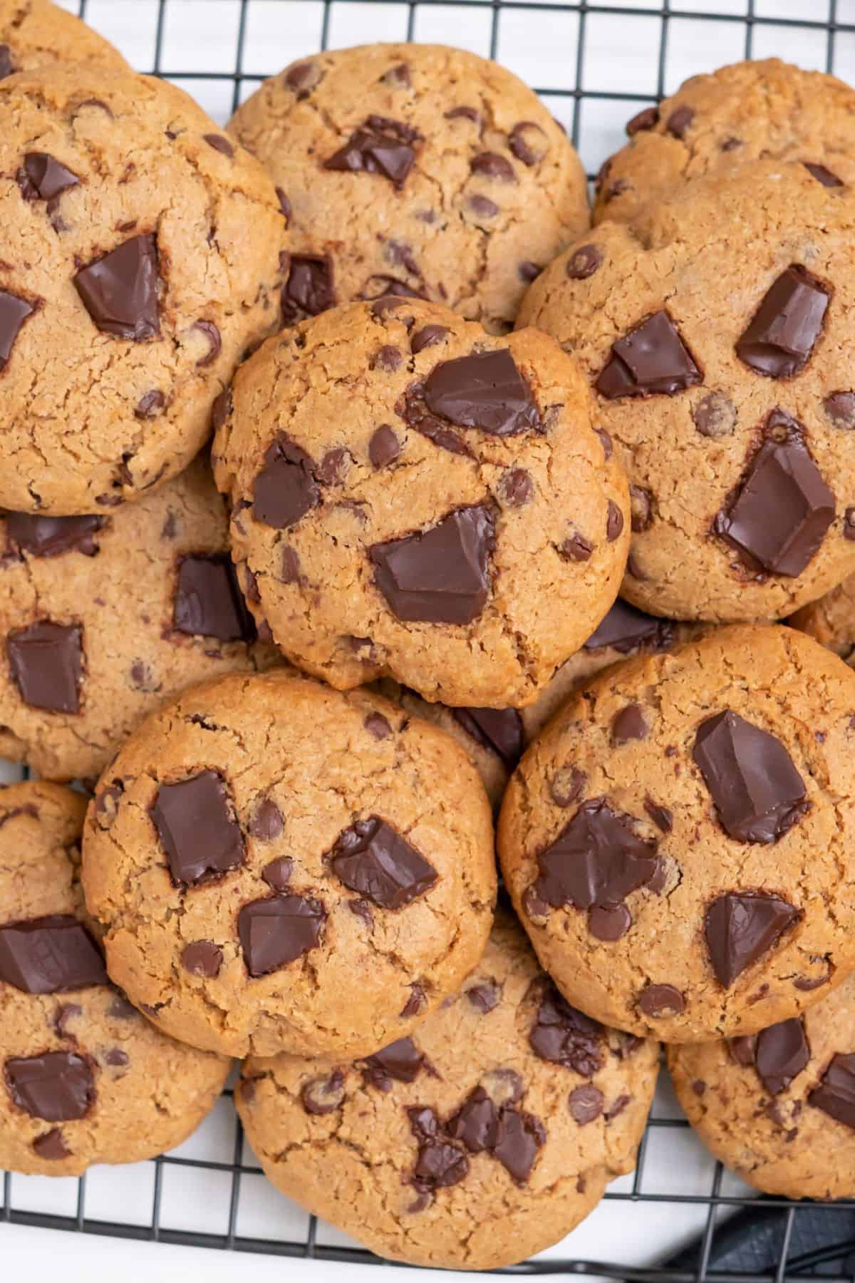A batch of almond flour chocolate chip cookies on a cooling rack.