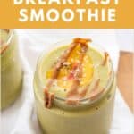 Two frosty glass of a green superfood breakfast smoothie topped with peach slices, hemp seeds, and almond butter.