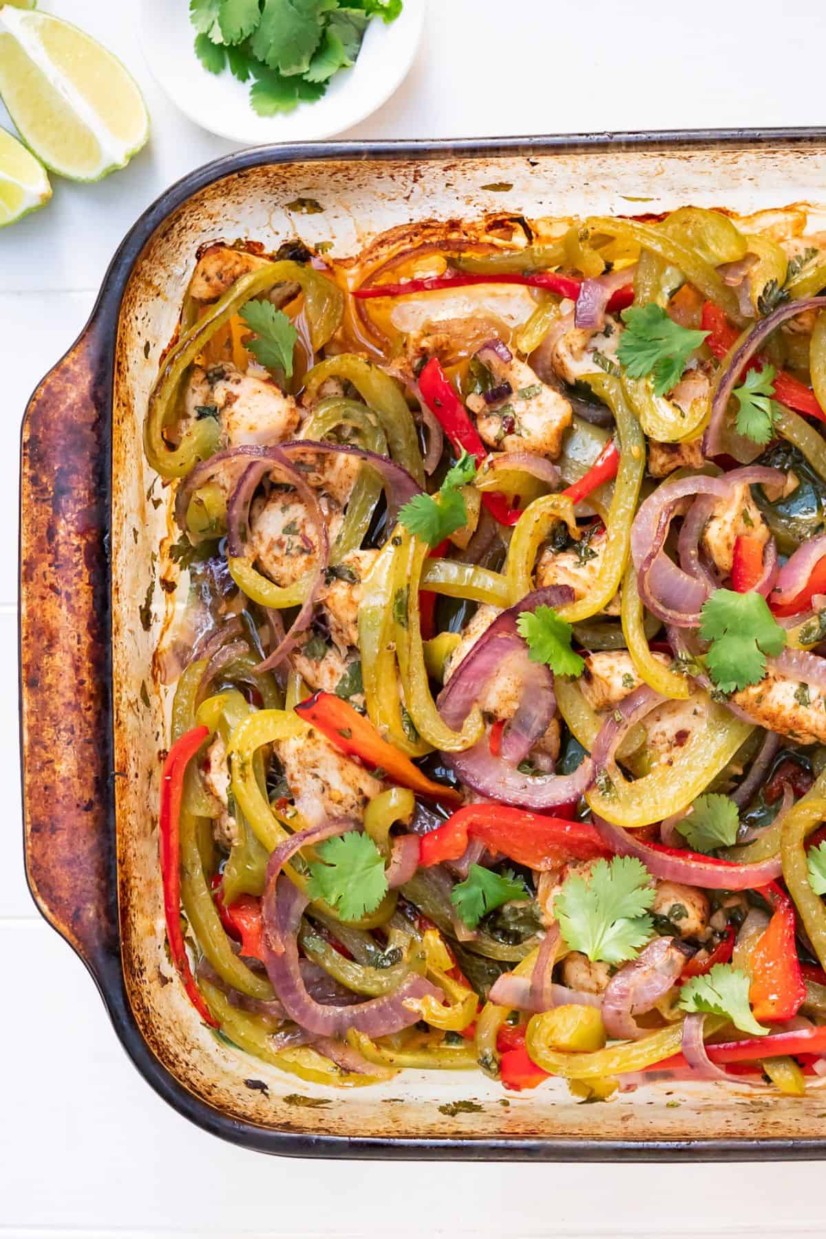 A tray of freshly baked chicken fajitas with healthy ingredients.