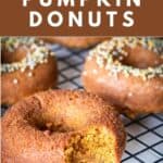 Three paleo pumpkin donuts with different toppings and a bite removed to show the traditional donut crumb.