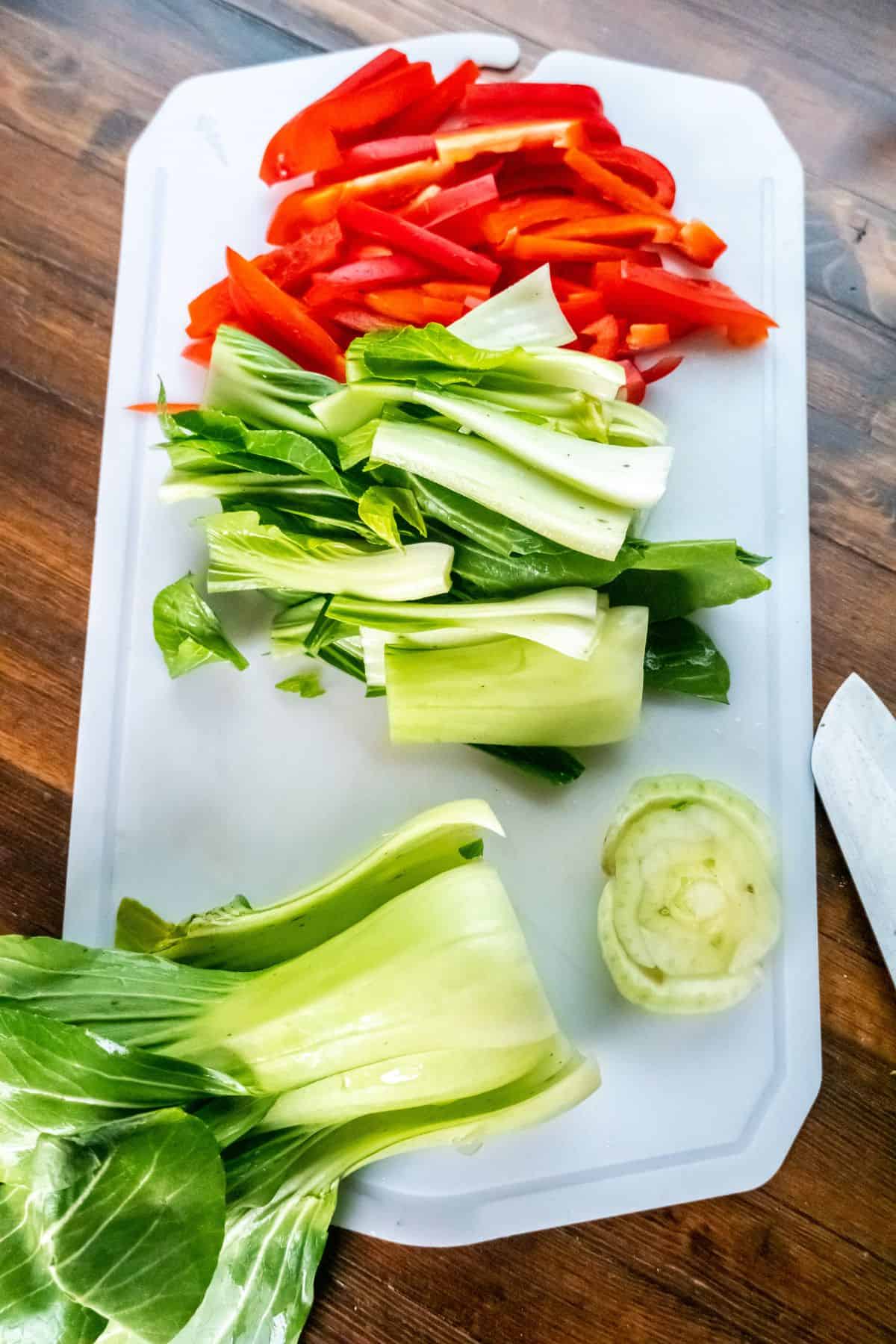 Chopped red bell pepper and baby bok choy to put in the soup.