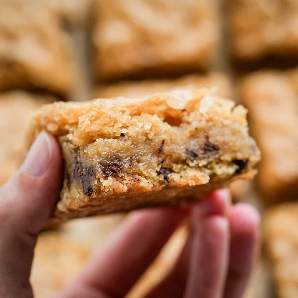 A close up of a gluten-free blondie to show the soft and gooey inside.